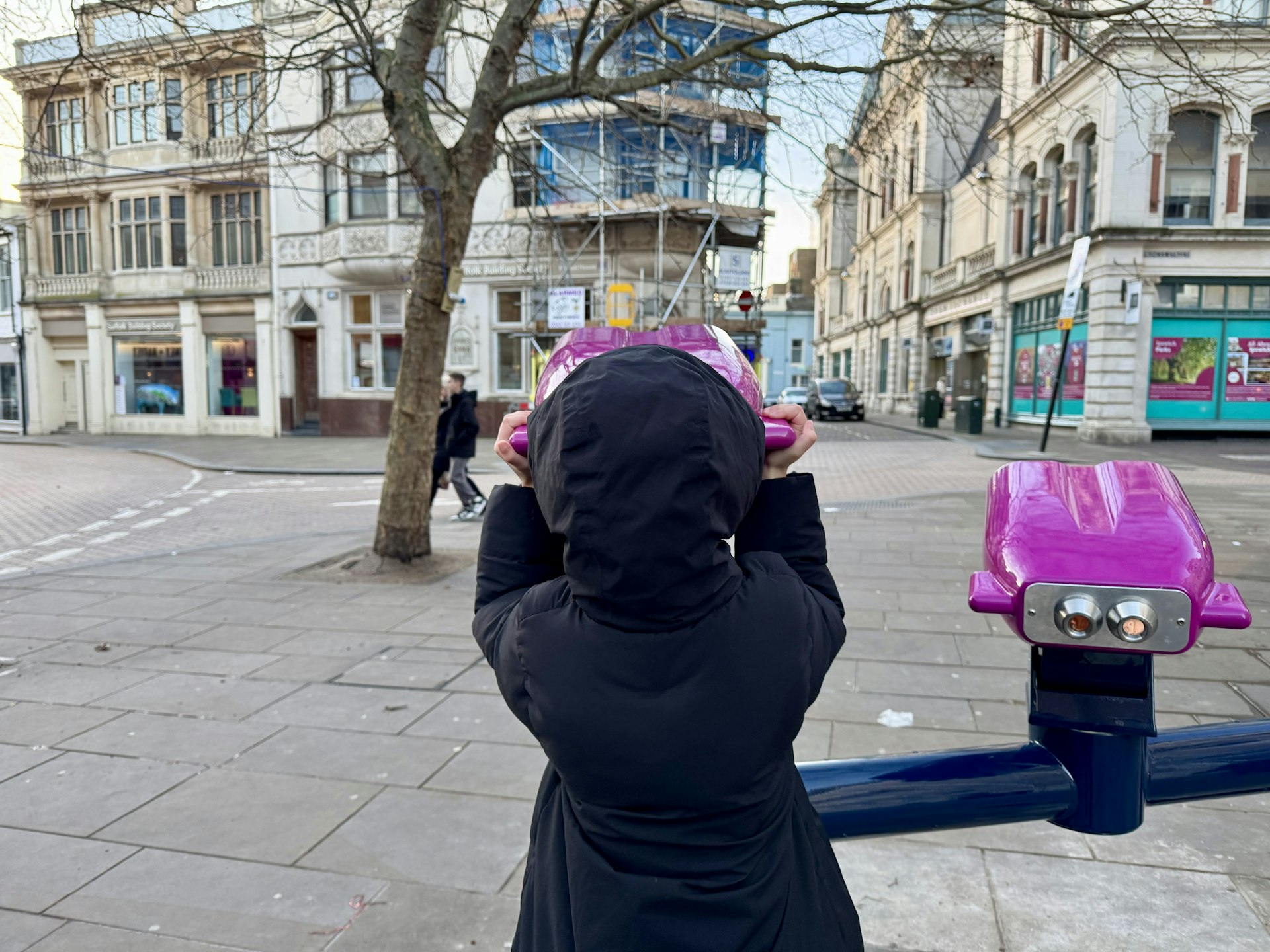 A young girl looking into the past at the Buttermarket
